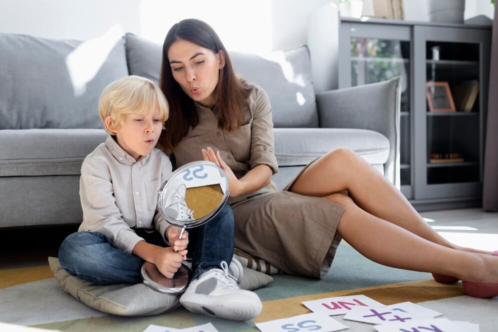 young-woman-doing-speech-therapy-with-little-blonde-boy_23-2149110222